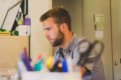 bearded guy at work on computer